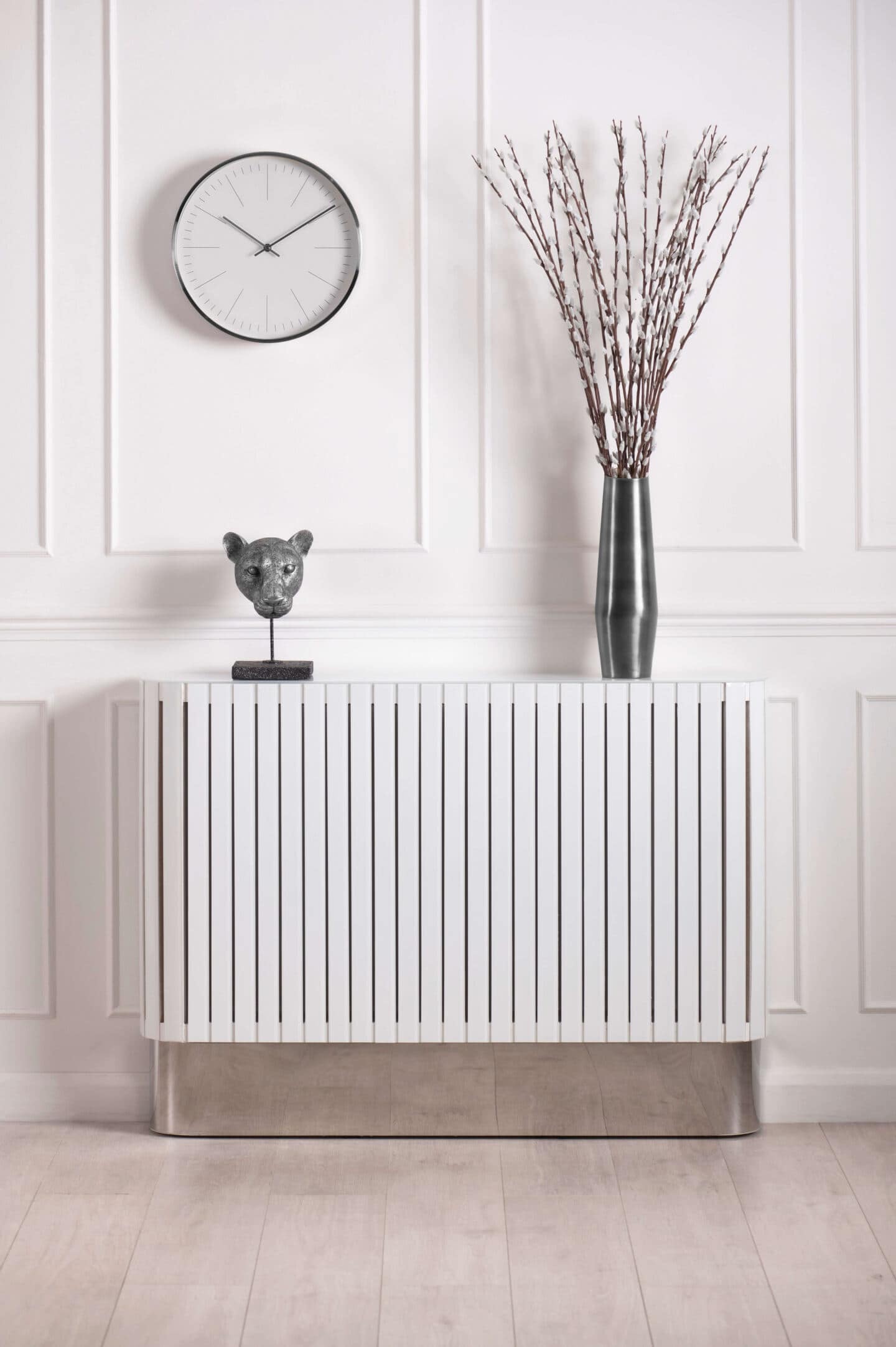 A white radiator cover with a white panelled wall behind