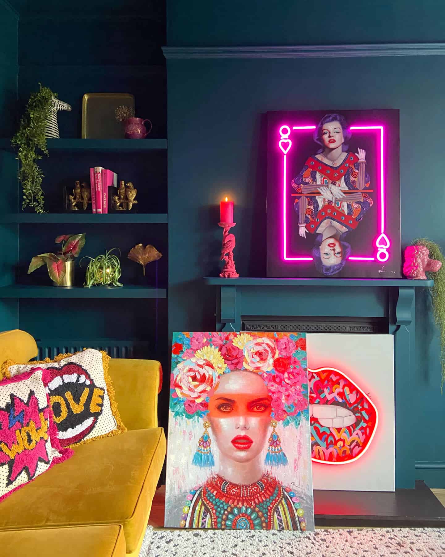 A colour drenched teal room with fireplace also painted teal. The room is full of bright and neon accessories from Audenza