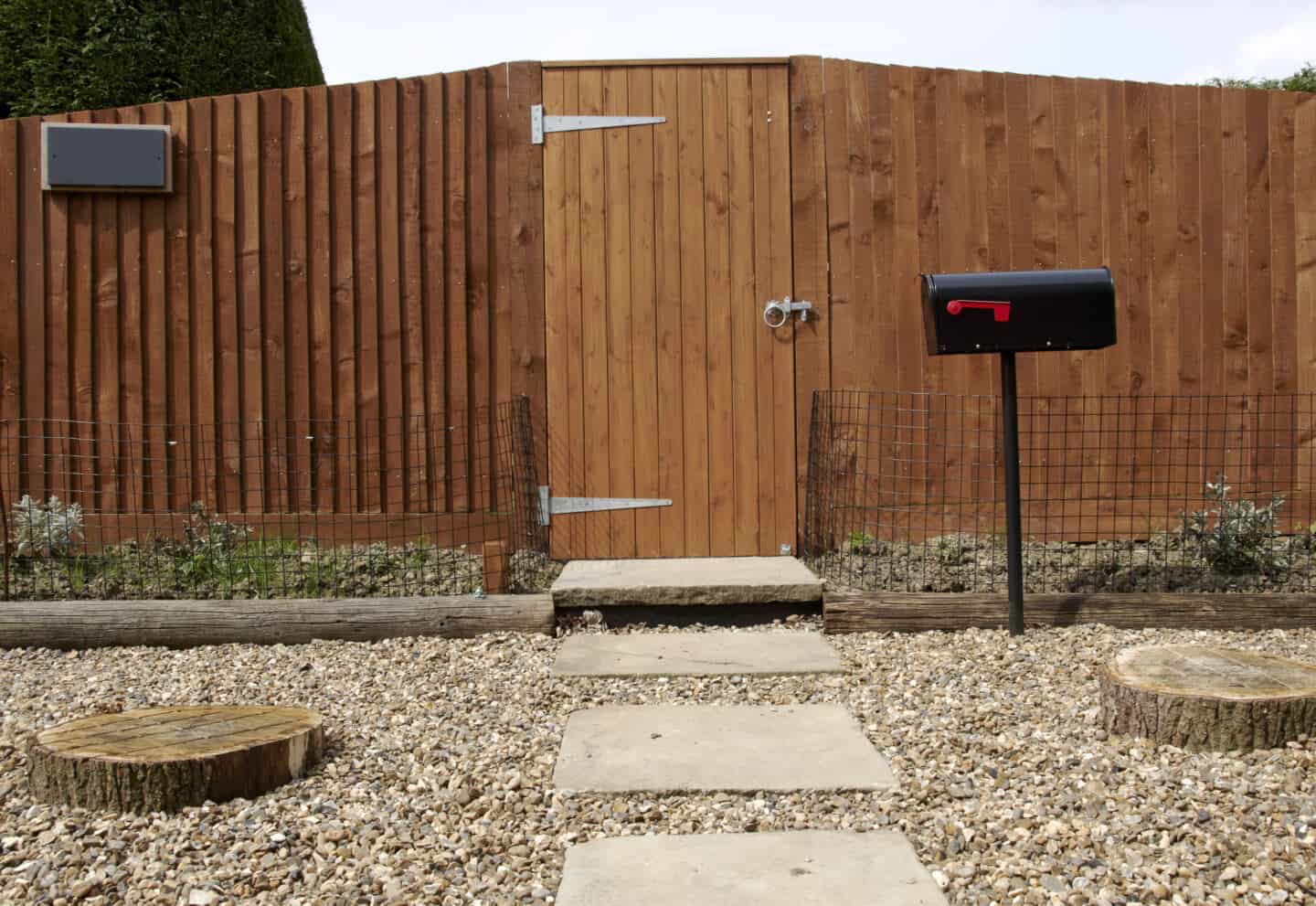 A tall wooden garden fence provides extra home security