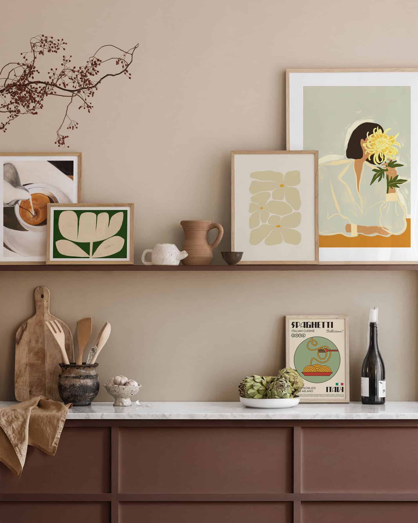 Frames on a picture ledge leaning against the wall in a minimalist kitchen