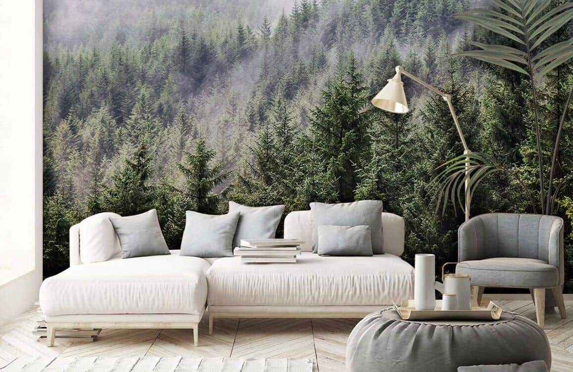 Ever Wallpaper mural of a forest covered in mist behind a minimalist white sofa and a grey pouffe