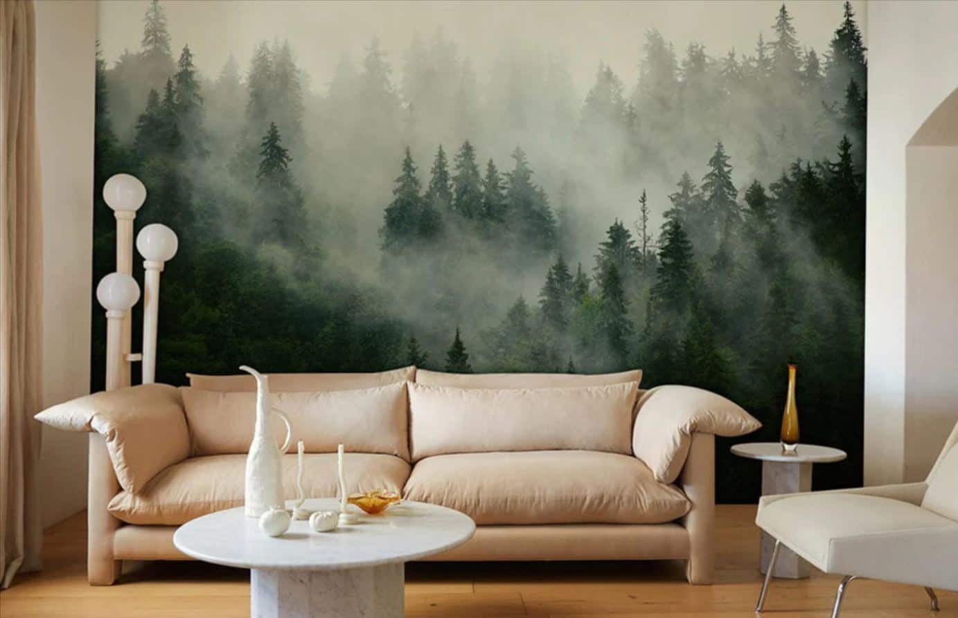 Ever Wallpaper mural of a forest covered in mist behind a modern cream sofa and a white marble coffee table