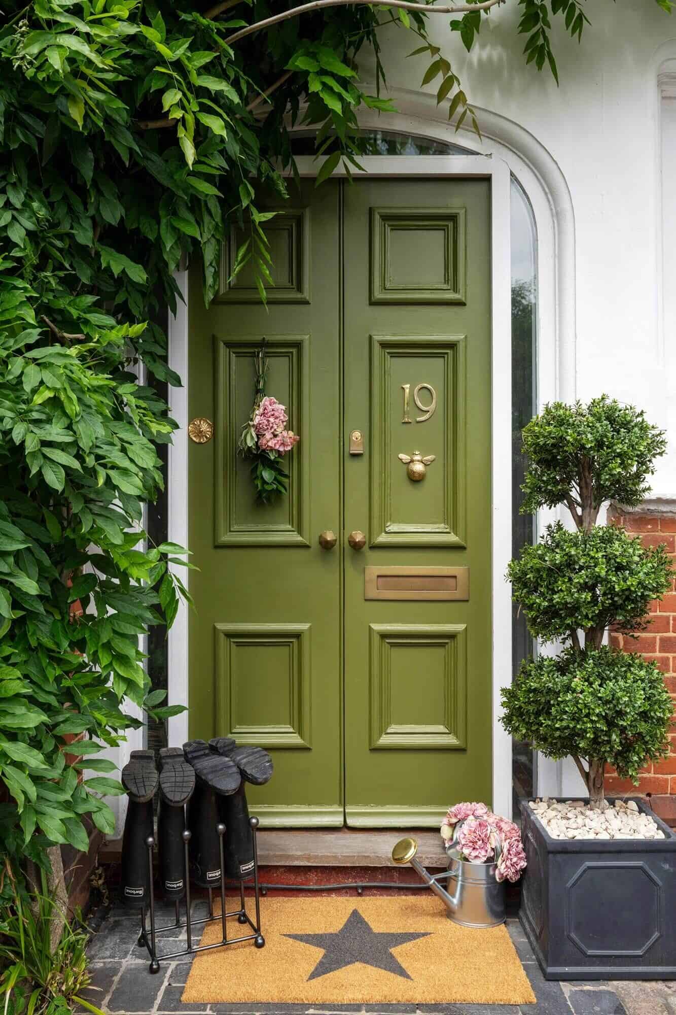 A front door painted in a vibrant shade of green is an easy DIY home project