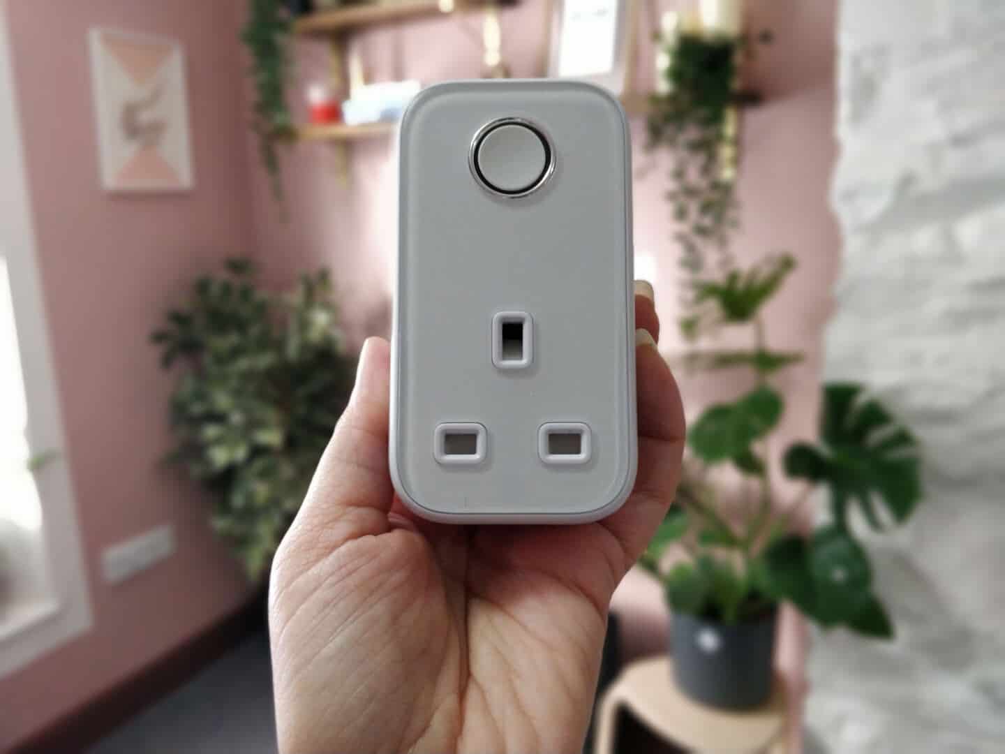 a female hand holding a Hive smart plug