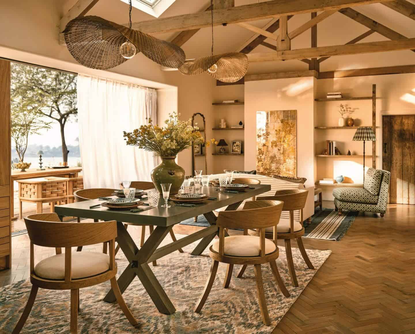 A beautiful dining room with sliding doors that open out to the garden