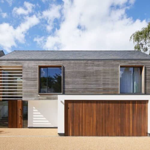 a modern home with wood cladding and double garage