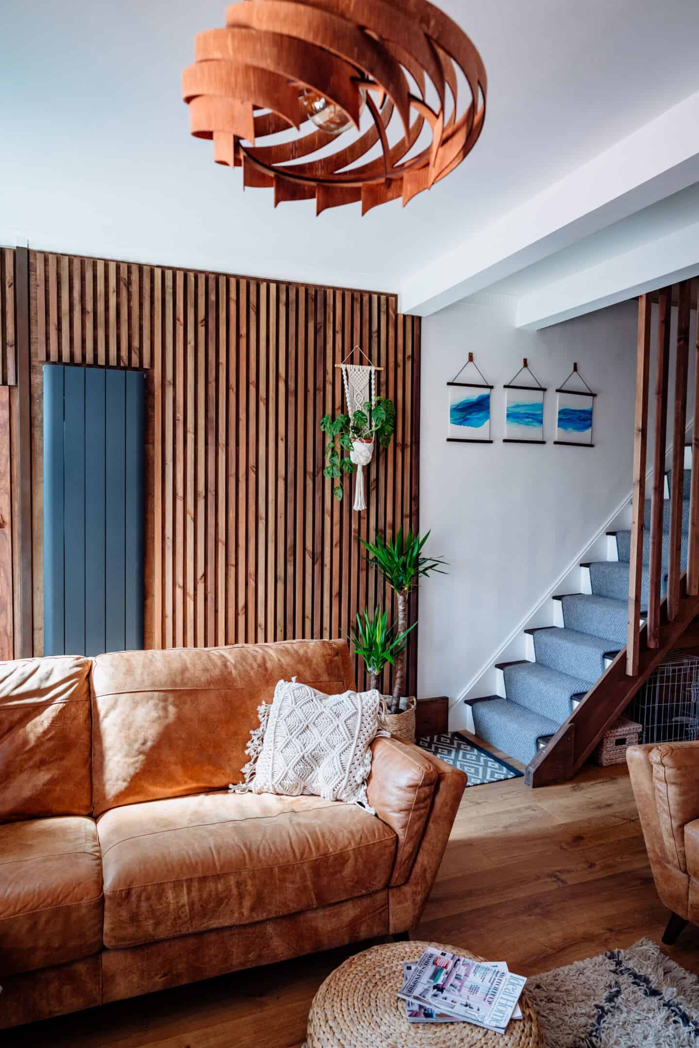 A living room with vertical slat wooden panelling
