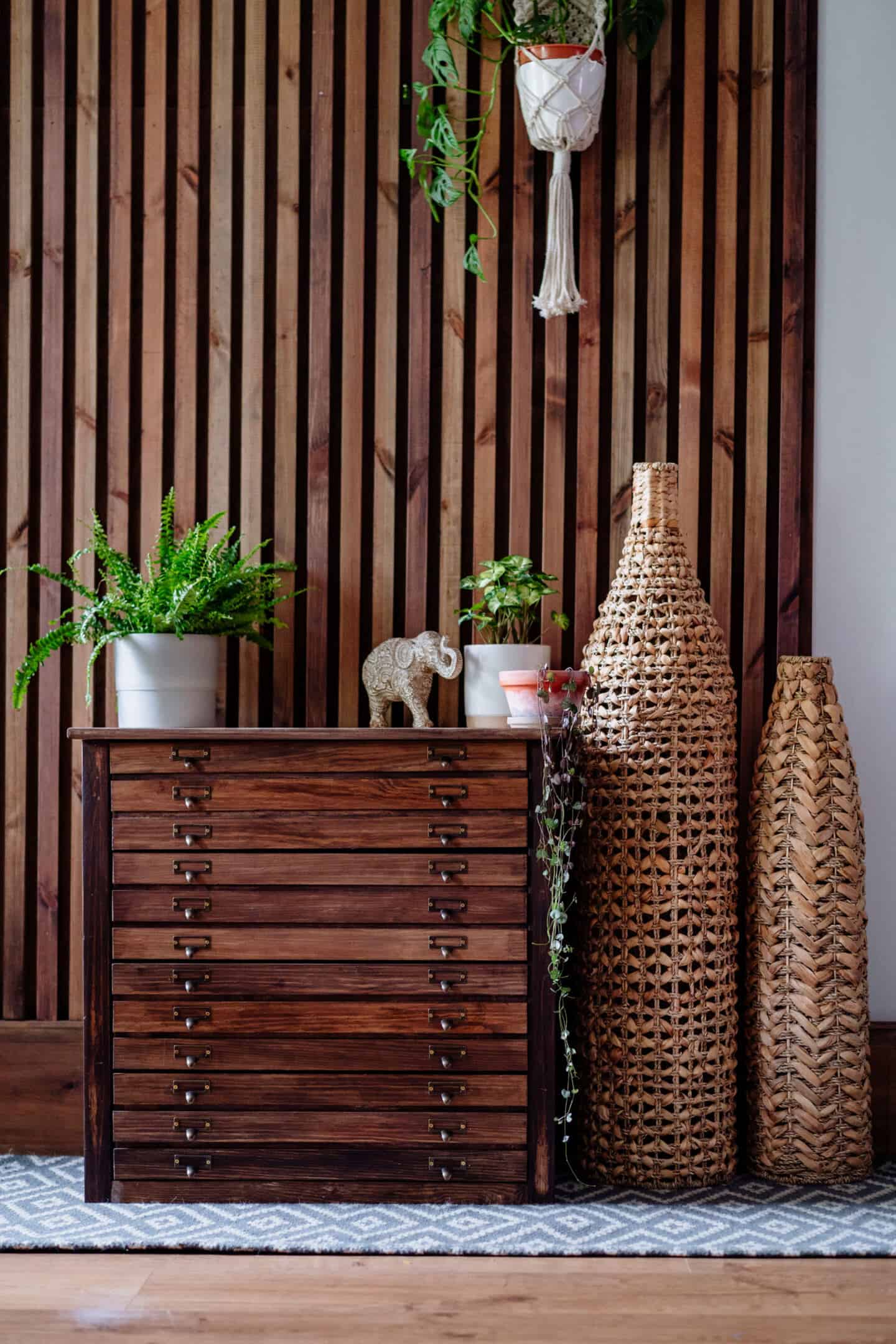 A living room with vertical slat wooden panelling