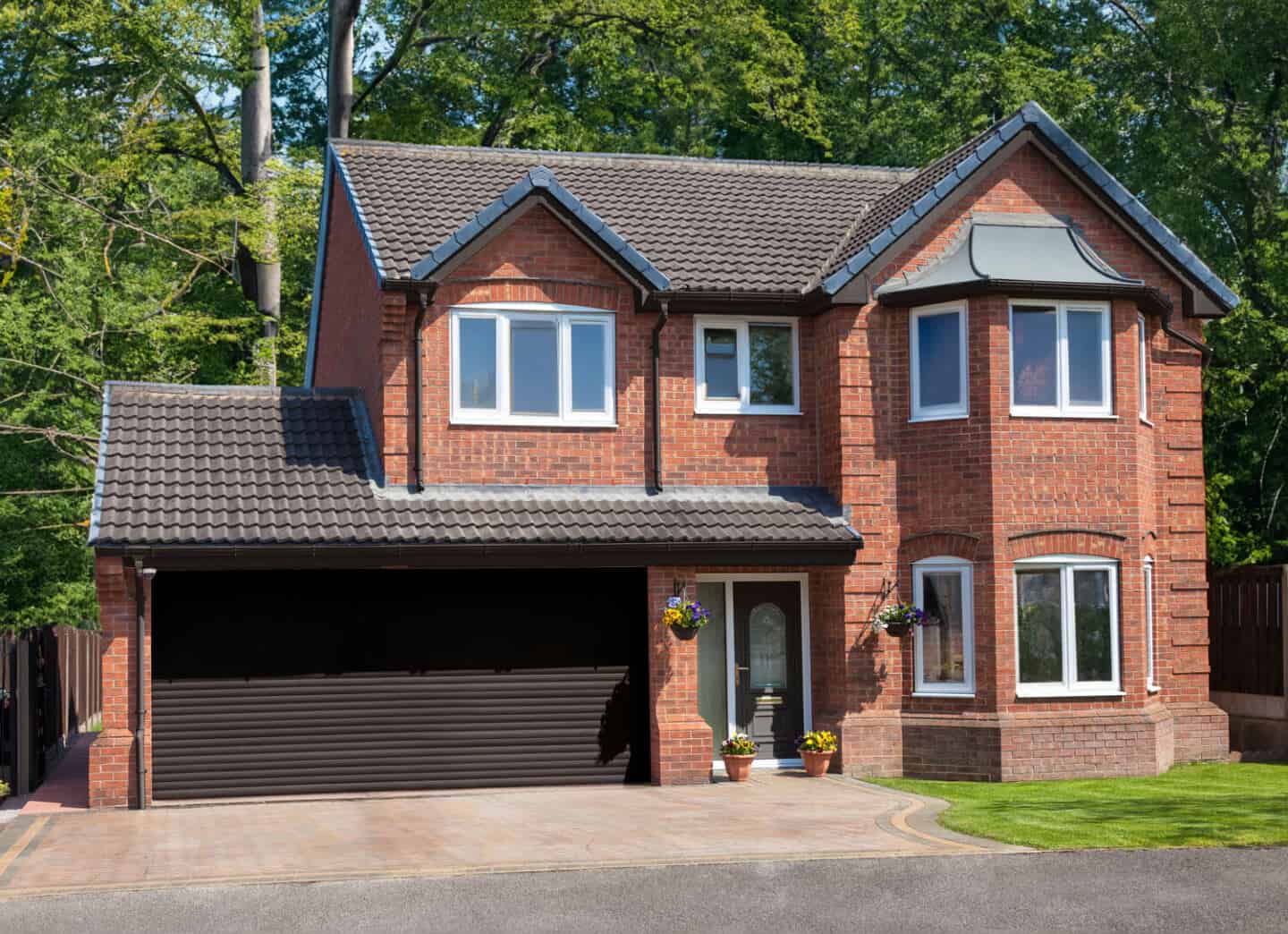 A traditional red brick detached house with integral double garage