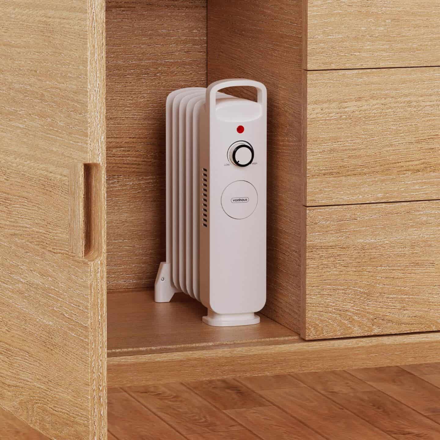 Mini oil-filled radiator stored inside a wooden wardrobe